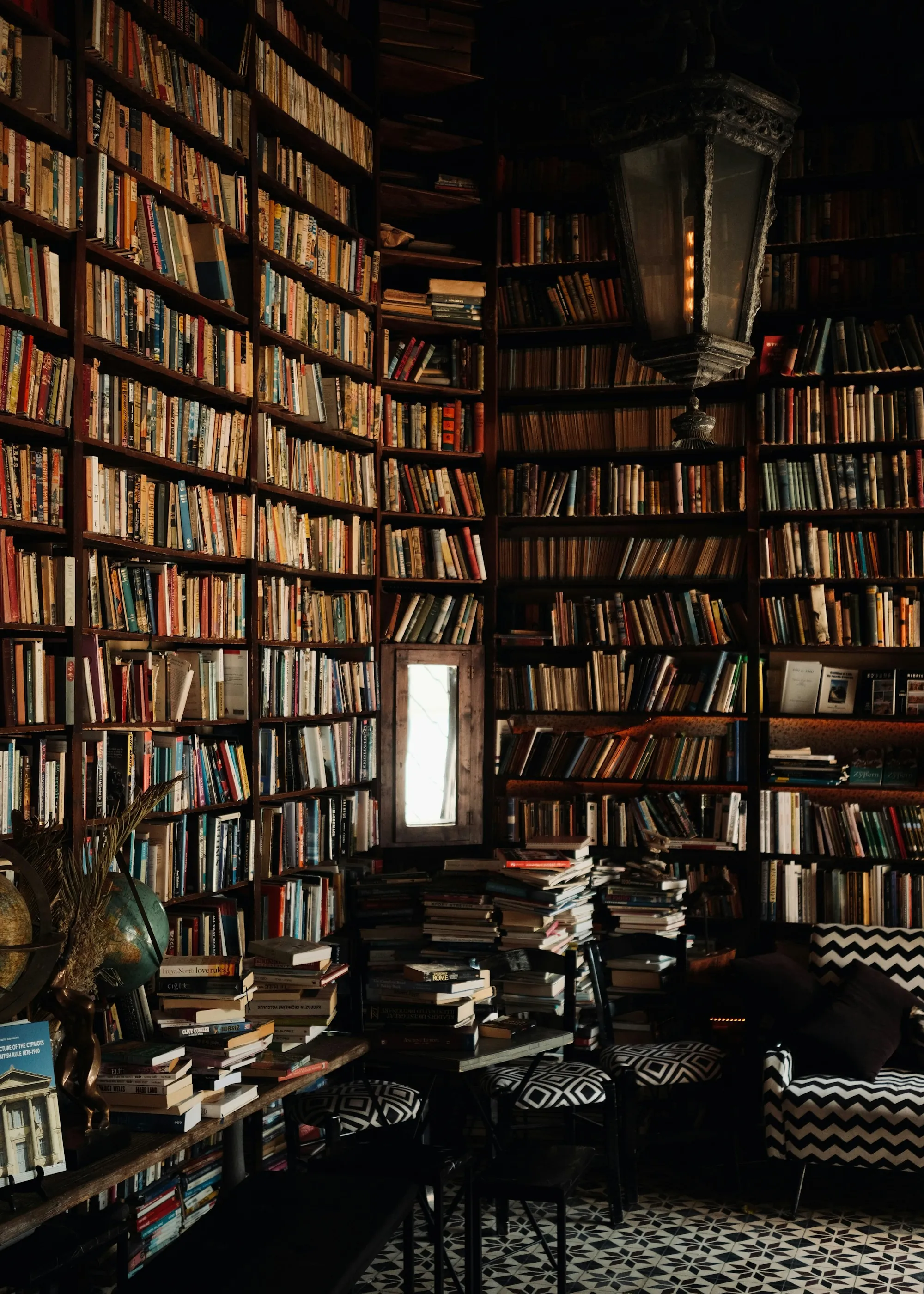 Walls of old books in a dim library
