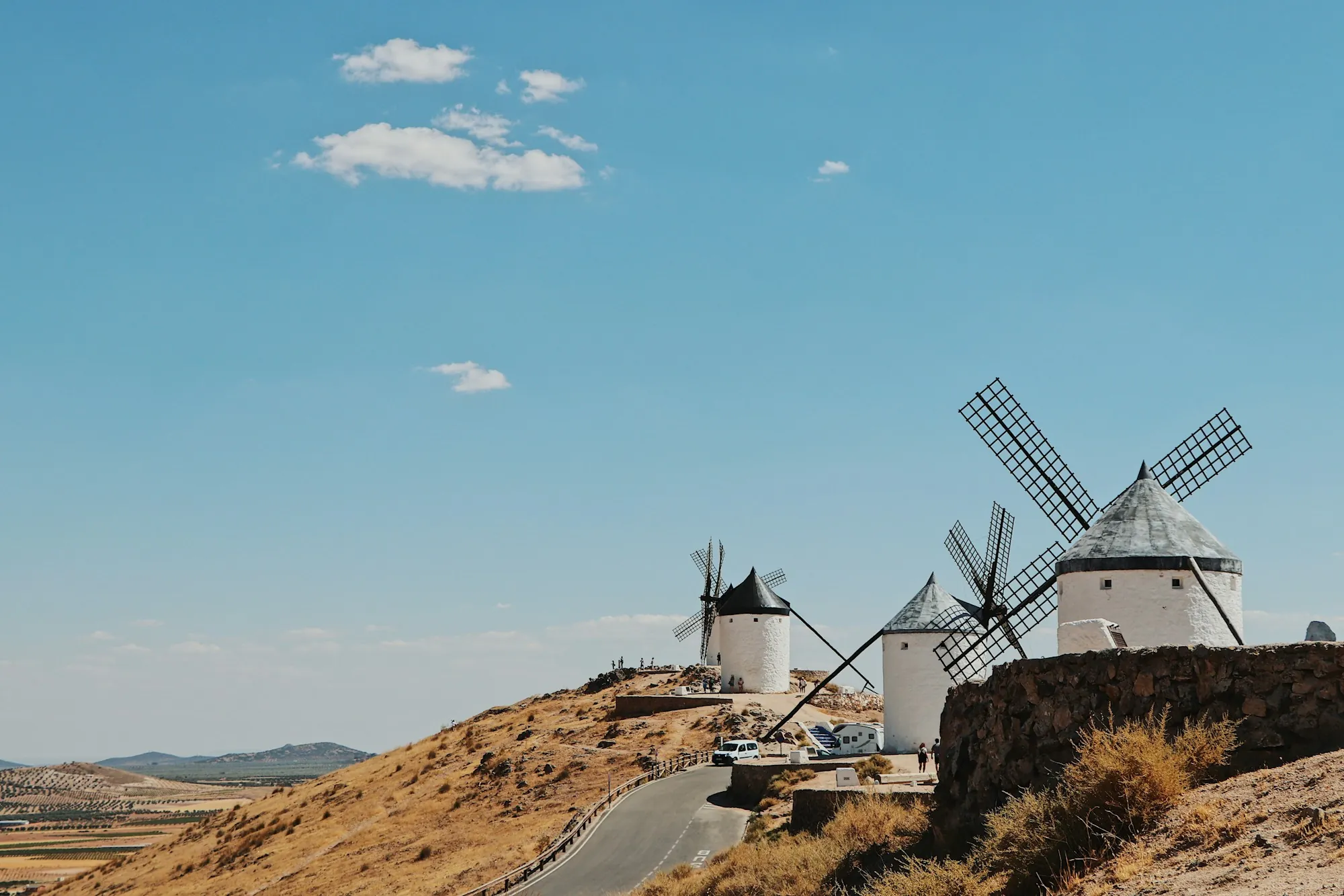 A white windmill above brown fields