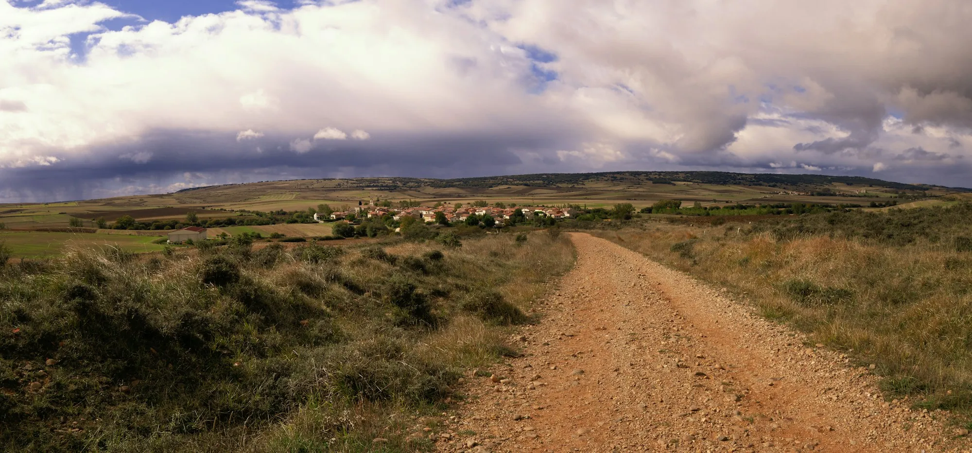 A dirt road across a field
