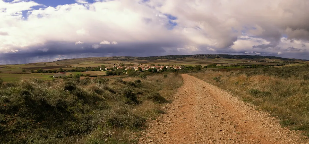 A dirt road across a field